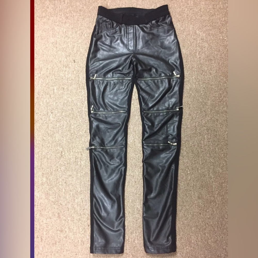 Stylish women's tight faux leather pants with zippers.